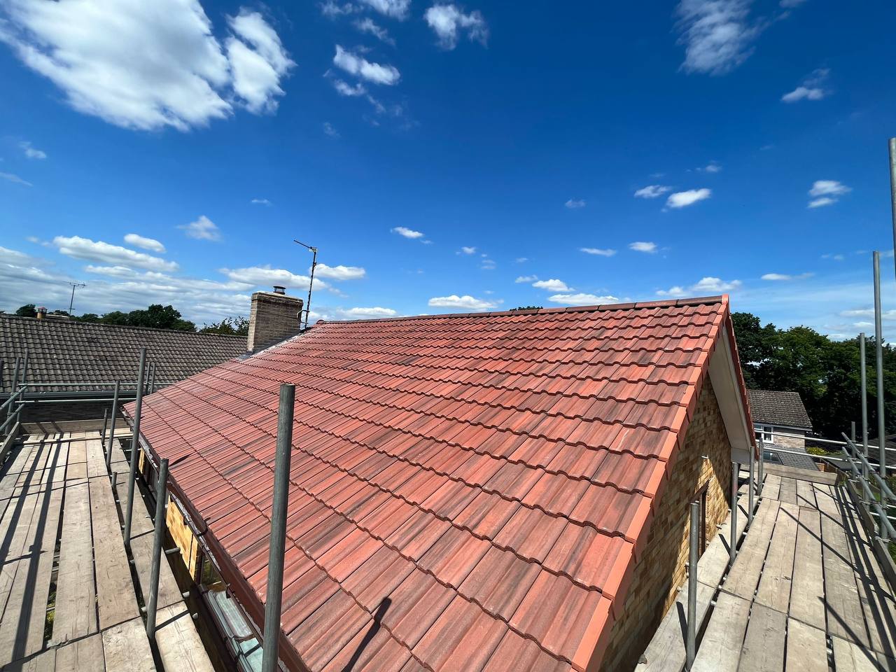 Fresh red clay tiled roof in sunshine