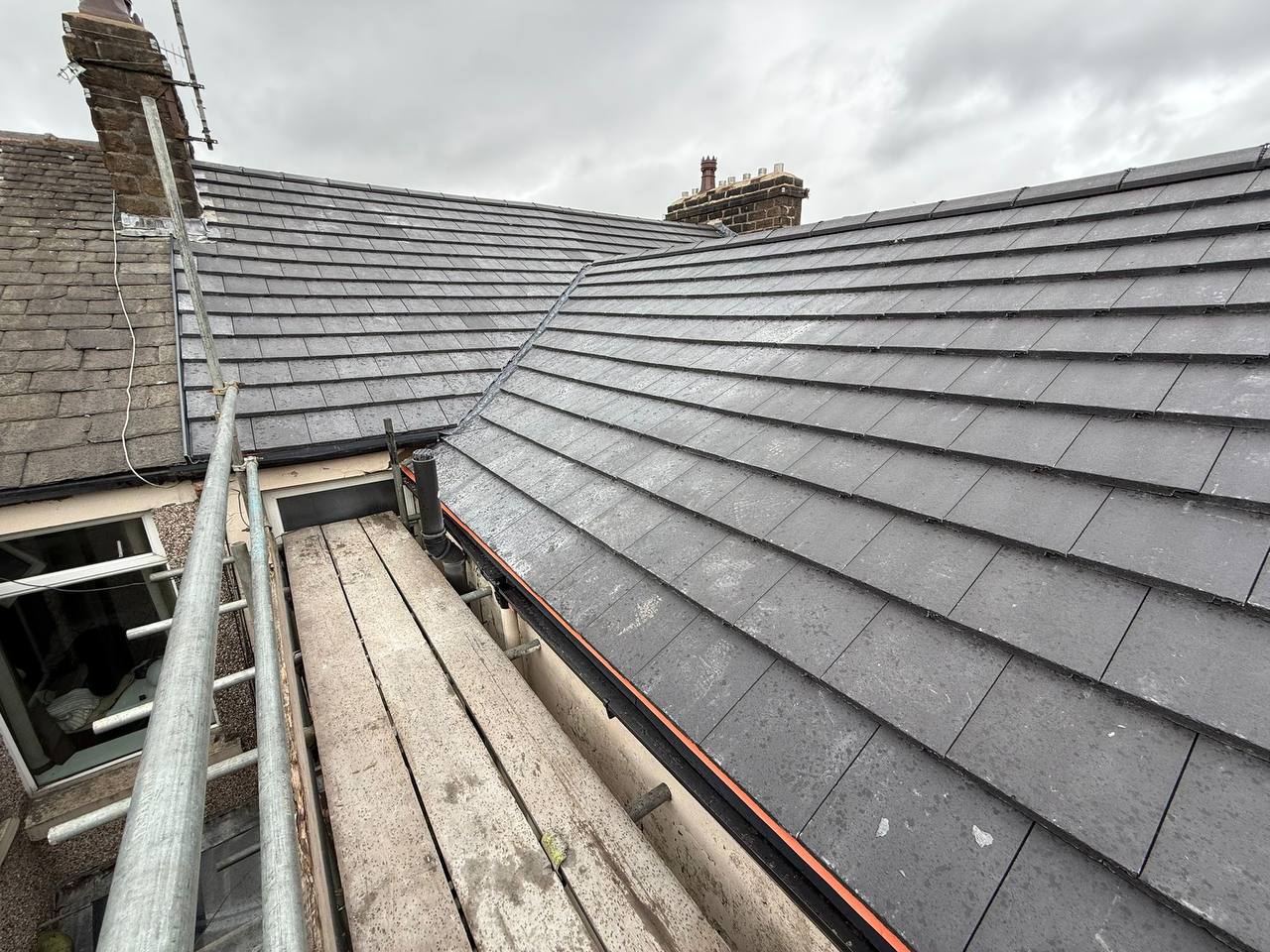 Grey slate roof installation with valley
