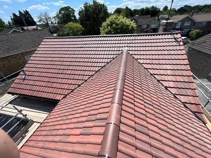 Newly tiled red roof on a UK home