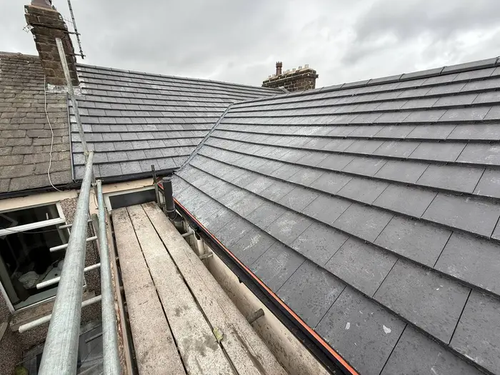 Grey slate roof installation with valley
