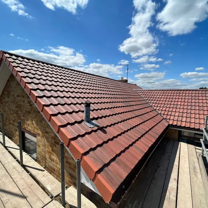 Pitched red roof with new flashing